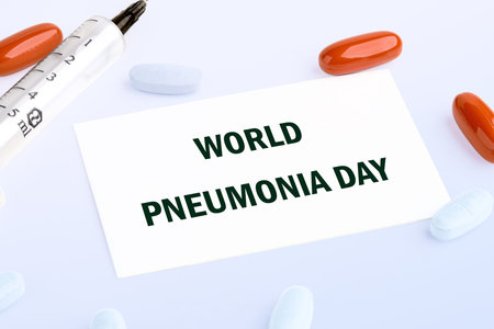 WORLD PNEUMONIA DAY written on a white business card lying on a light backgroundの写真素材