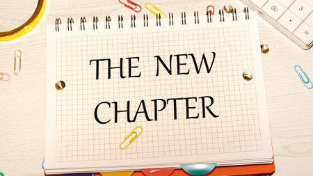 Conceptual the new chapter symbol. Copy space. The new chapter words written in a checkered notebook