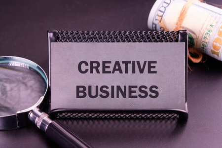 Business concept. CREATIVE BUSINESS written on the card in dark colorsの写真素材