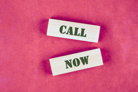 Conceptual call now symbol. Copy space. Call now message written made up of wooden blocksの写真素材