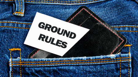 Conceptual ground rules symbol. Copy space. GROUND RULES words written on a white card peeking out of a business card holder in a jeans pocketの写真素材