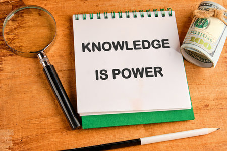 KNOWLEDGE IS POWER words in a notebook on a papyrus backgroundの写真素材
