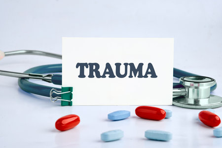 TRAUMA written on a white business card on a light backgroundの写真素材