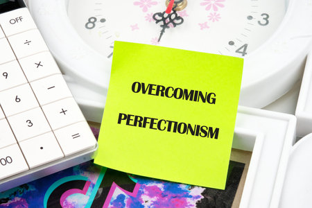 Business Overcoming perfectionism concept. Copy space. Concept words Overcoming perfectionism on the sticker, front viewの写真素材