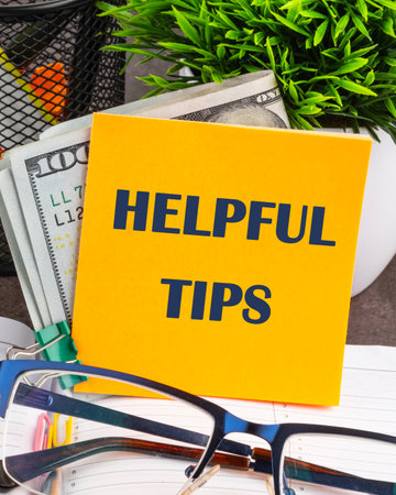 Helpful Tips words on a yellow sticker, vertical concept photoの写真素材