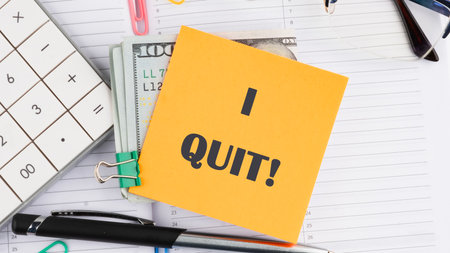 Life and business motivational inspirational concept. I QUIT on a yellow sticker on top of dollar billsの写真素材