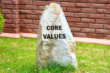 Business and core values concept on a stone on the background of a fence, red brick wallsの写真素材