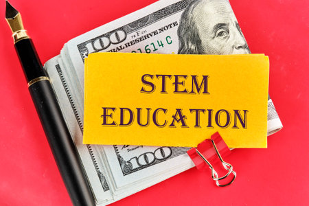 STEM Education. Science Technology Engineering Mathematics. STEM EDUCATION words on yellow paper on...