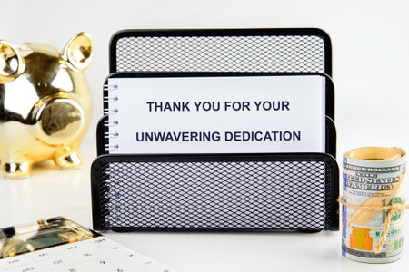 A note expressing gratitude for unwavering dedication is prominently placed on a desk alongside a...