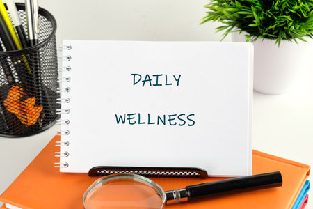A neatly organized workspace features a notebook displaying daily wellness activities, accompanied by a magnifying glass, stationary, and a potted plant, promoting a healthy lifestyle.の写真素材
