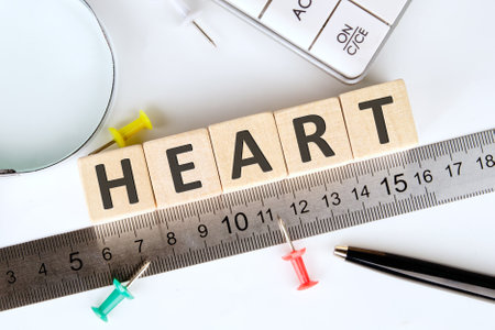 A word HEART written on wooden cubes, arranged according to a ruler using a magnifying glass and pins, creating an inspiring atmosphere for work or study.の写真素材