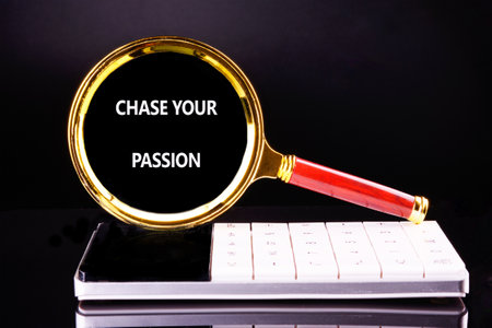 Motivation Quote. CHASE YOUR PASSION words on a black background through a magnifying glass on a calculator.の写真素材