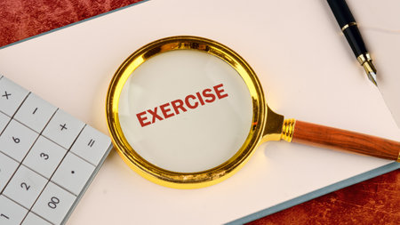 Body, mind, spirit and soul concept. A word EXERCISE through a magnifying glass on a blank sheet of...