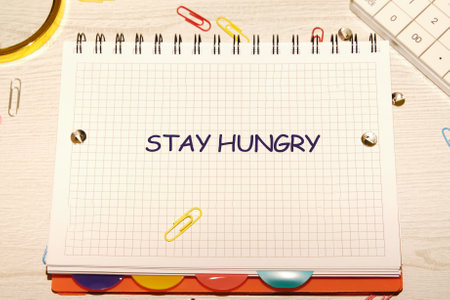 Concept Phase STAY HUNGRY, a motivational message written on a grid notebook.