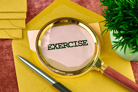 Body, mind, spirit and soul concept/ A word EXERCISE through a magnifying glass on a note from an envelope.の写真素材
