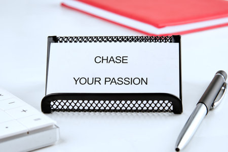 Motivation Quote. CHASE YOUR PASSION words on a white business card, front view.の写真素材