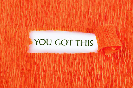 YOU GOT THIS words written under the orange paper on a white background.の写真素材