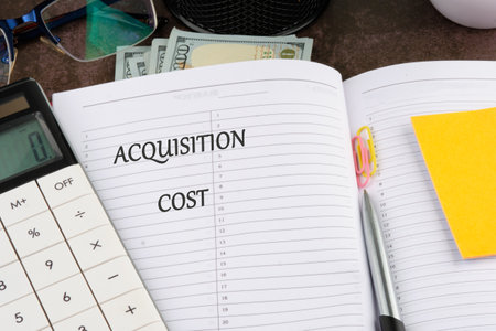 A conceptual phrase on the topic of ACQUISITION COST business. Business concept.の写真素材