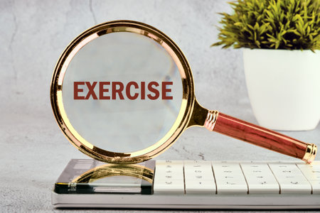 Body, mind, spirit and soul concept A word EXERCISE through a magnifying glass, close-up, front view.の写真素材