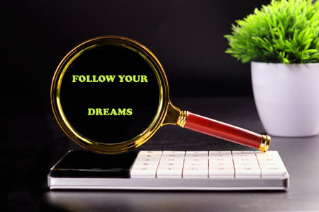 Follow your dreams motivational graduate education message. FOLLOW YOUR DREAMS written on a black...