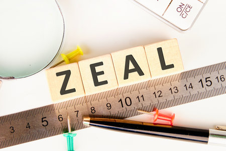 The concept word ZEAL is assembled from wooden cubes. The composition emphasizes motivation