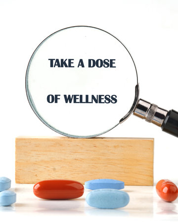 The concept phrase is TAKE A DOSE OF WELLNESS. Health concept. Pharmacological preparations, medicinal products.の写真素材