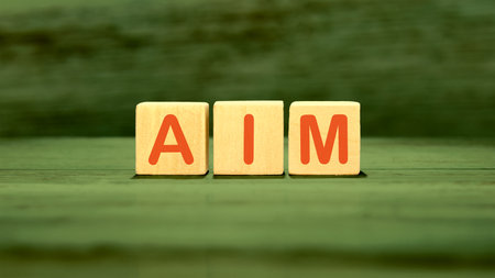 The AIM concept word is assembled from cubes. Business concept.
