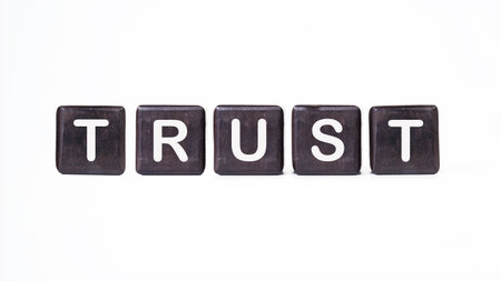 The concept word TRUST is assembled from wooden cubes. Investment based on trust concept.の写真素材