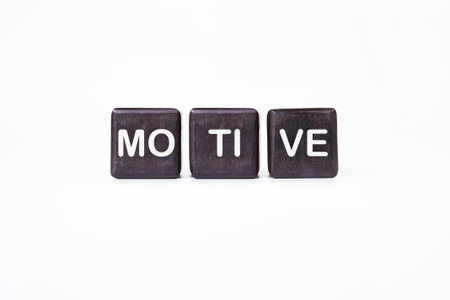 The concept word MOTIVE is assembled from wooden cubes. business motivational concept.
