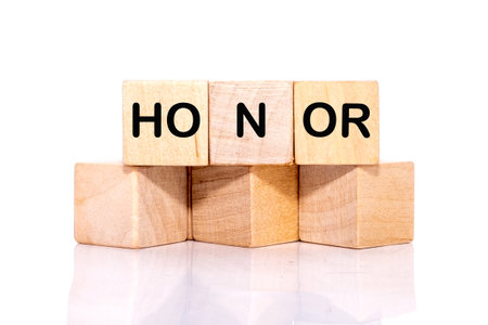 The HONOR concept word is assembled from wooden cubes. ethics, respect, code, honesty, integrity concept.の写真素材