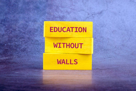 Copy space; Concept words EDUCATION WITHOUT WALLS on wooden blocks on a bright backgroundの写真素材
