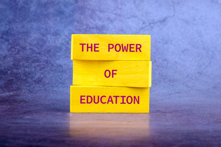 Concept words THE POWER OF EDUCATION on wooden blocks on a bright background.の写真素材