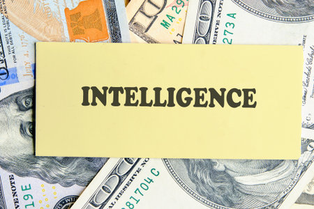 INTELLIGENCE text written on yellow paper on the background of banknotes. Futuristic Concept of Intelligence, science and mind.の写真素材