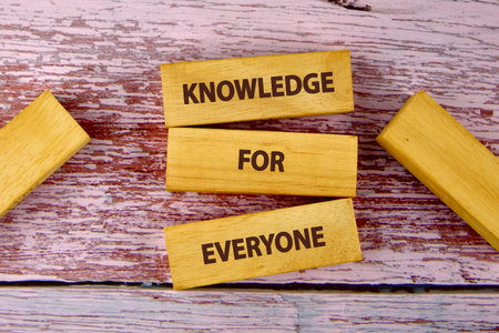 Education Concept text KNOWLEDGE FOR EVERYONE is assembled from blocks on wooden boards, top view.の写真素材