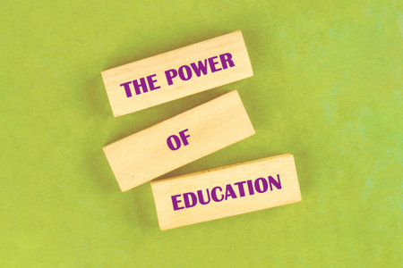 Business and Words Matter concept. Copy space. THE POWER OF EDUCATION assembled from blocks on a...