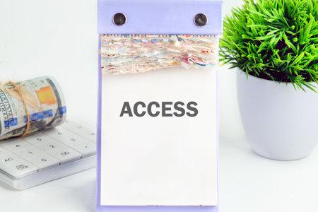 ACCESS text written on a desktop calendar on a white background. Business and accessible concept....
