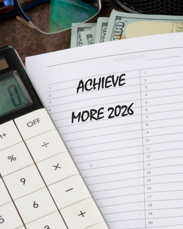 On a desk, money, a planner, and a calculator sit, suggesting financial planning and goal-setting for future prosperity.の写真素材