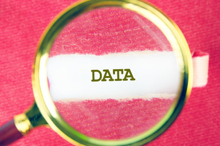 DATA word was found using a magnifying glass under a piece of paper. Business strategy success concept.の写真素材