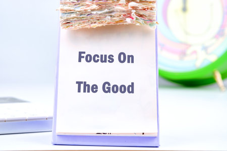 A desk is adorned with a colorful inspirational display that urges one to focus on the good in life....