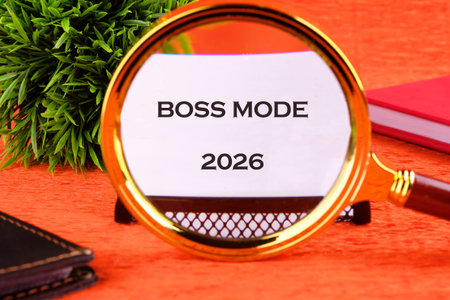 A magnifying glass reveals the words Boss Mode on a bright orange background. Nearby, a green plant...