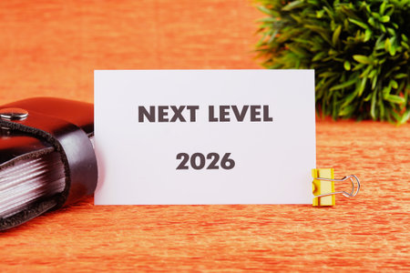 A card displaying the words next level is placed on a vibrant orange surface.の写真素材