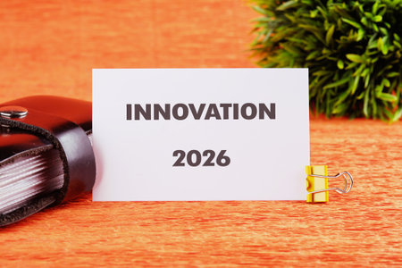 A notepad sits on a bright wooden table, featuring the word innovation and the year 2026. Lush...