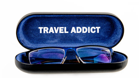 A pair of glasses sit nestled inside their dark case. The case is lined with deep blue fabric that...