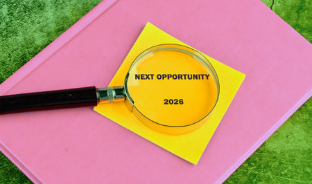 A magnifying glass is positioned over a yellow note with the words Next Opportunity 2026. The note...