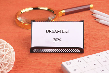A calming desk setup features a small sign saying Dream Big for the year 2026. Nearby are a...