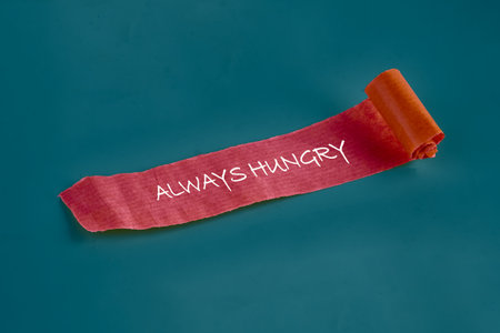A vibrant piece of textured paper rolls out across a solid blue background, showing the bold phrase...