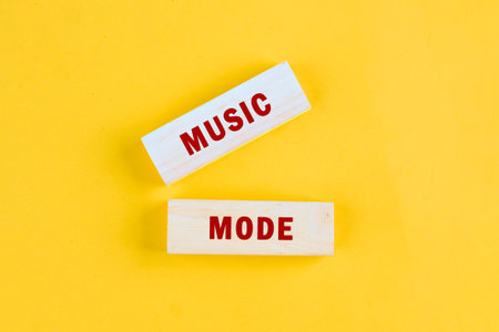 Bright yellow blocks display the words music mode, inviting a sense of joy and enthusiasm. These vibrant letters suggest a celebration of sound and rhythm, perfect for inspiration.の写真素材