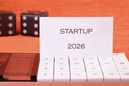 A calculator, dice, and a business card are visible. Business concept, success, and planning is demonstrated with objects on a solid colored surface.の写真素材