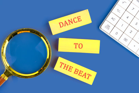 Bright yellow cards display the phrase Dance to the Beat, encouraging energetic movement.の写真素材