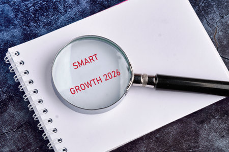 A magnifying glass is placed over a notebook revealing the words smart growth 2026. This scene...